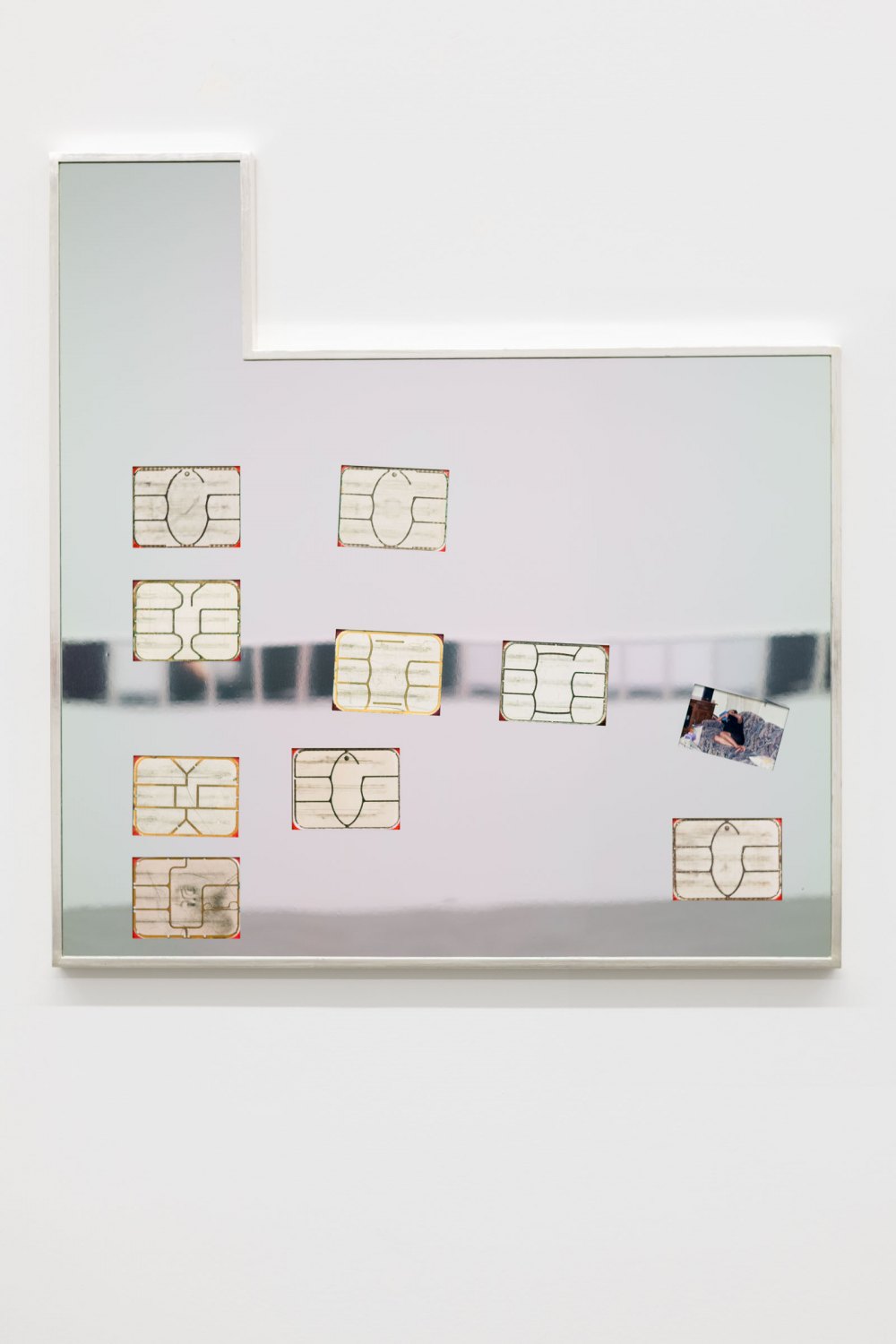 Flagged Identity (5), 2021 Archival pigment prints of my active and inactivebank cards chips, found photo, mirror polished aluminum, and white gold leafed frame 126 x 121.5 x 6 cm