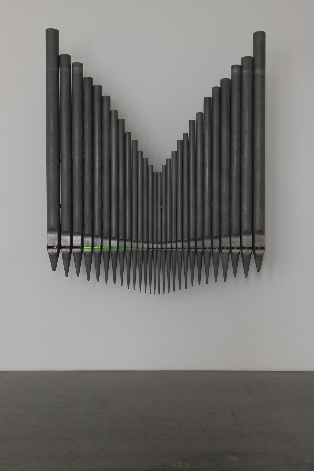 Jeremy Shaw Half-Life of Grace (1958), 2026 28 decommissioned zinc-based metal alloy church organ pipes, hand-blown uranium glass, ultra violet (UV) lights, electronic circuitry, transducer speakers, audio, stainless steel 300 x 255 x 58 cm