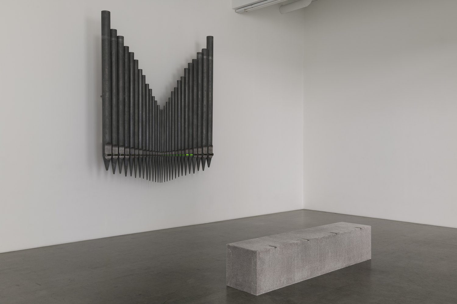 Jeremy Shaw&nbsp; Half-Life of Grace (1958), 2026&nbsp; 28 decommissioned zinc-based metal alloy church organ pipes, hand-blown uranium glass, ultra violet (UV) lights, electronic circuitry, transducer speakers, audio, stainless steel 300 x 255 x 58 cm&nbsp;